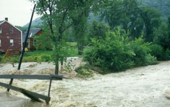 picture of water rushing over a floodplain by a bridge