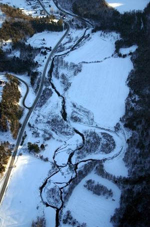 aerial view of meandering river in winter