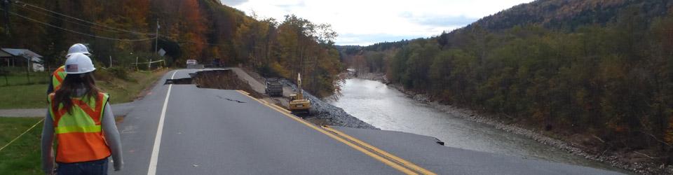 Road washed out by river